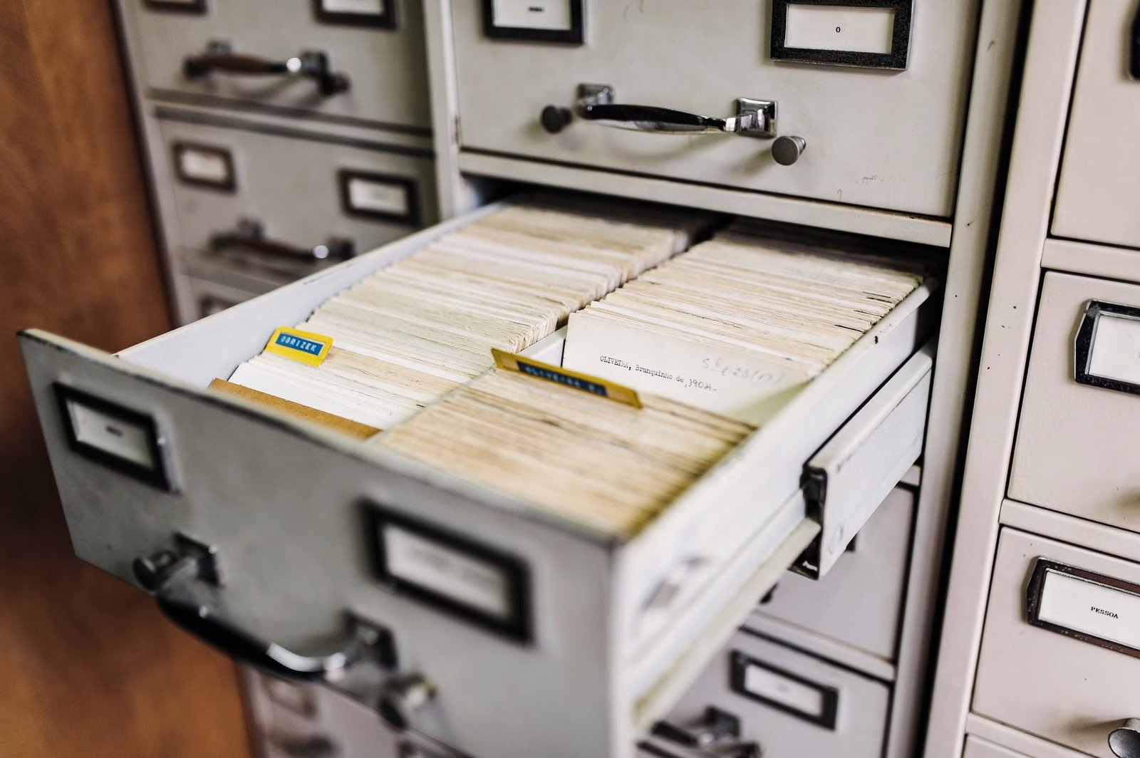 An open card-catalog drawer filled with indexed reference cards